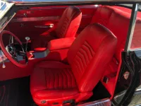 A Ford Falcon all red interior with new custom patterned bucket seats, door panels, center console, shift boot, and package tray - recovered at Topskins Upholstery in Midvale, Utah.