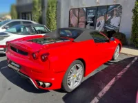 A red Ferrari F430 with a newly installed black convertible soft top in a black Twillfast canvas - expertly installed in Midvale, UT at Topskins Upholstery.