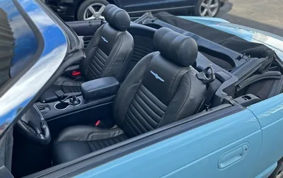 2003 Ford Thunderbird custom black leather bucket seats with powder blue embroidered logos and matching carpet by Topskins Upholstery near SLC, Utah and surrounding areas.
