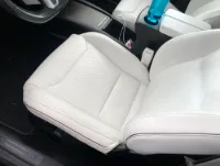 A 2016 Tesla Model Y seat bottom completely upholstered in the original white material with perforation.
