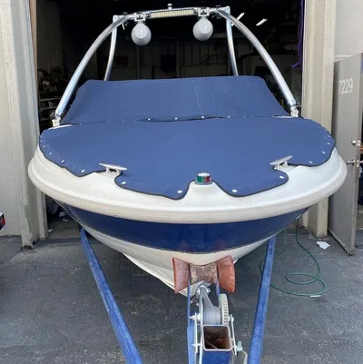 A two piece snap style canvas boat cover for both the bow and the cabin, in navy blue Sunbrella.