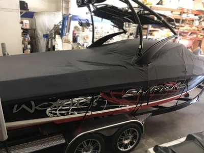 A custom made black boat winter storage or travel cover fabricated with high quality Top Gun canvas marine materials.