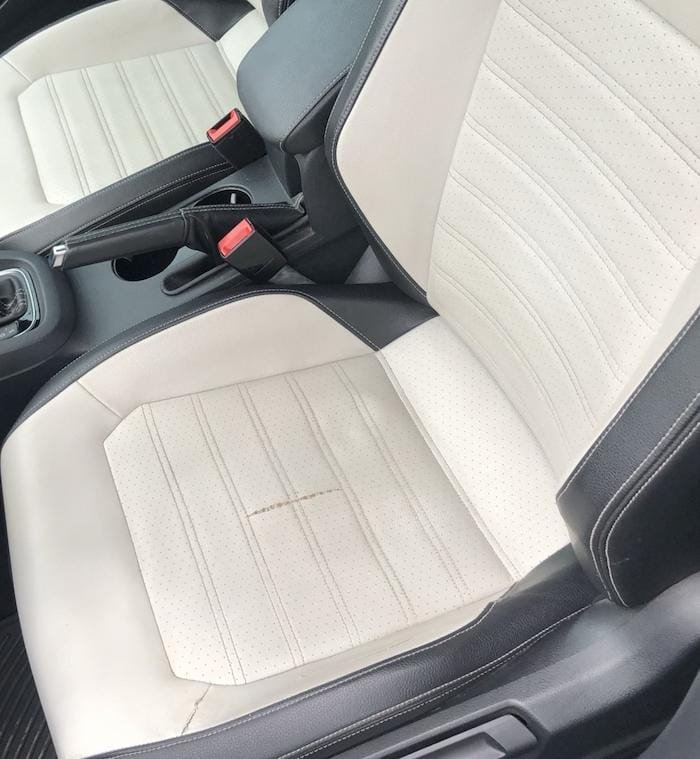 Before picture of a perforated seat repair in a Volkswagen Jetta.