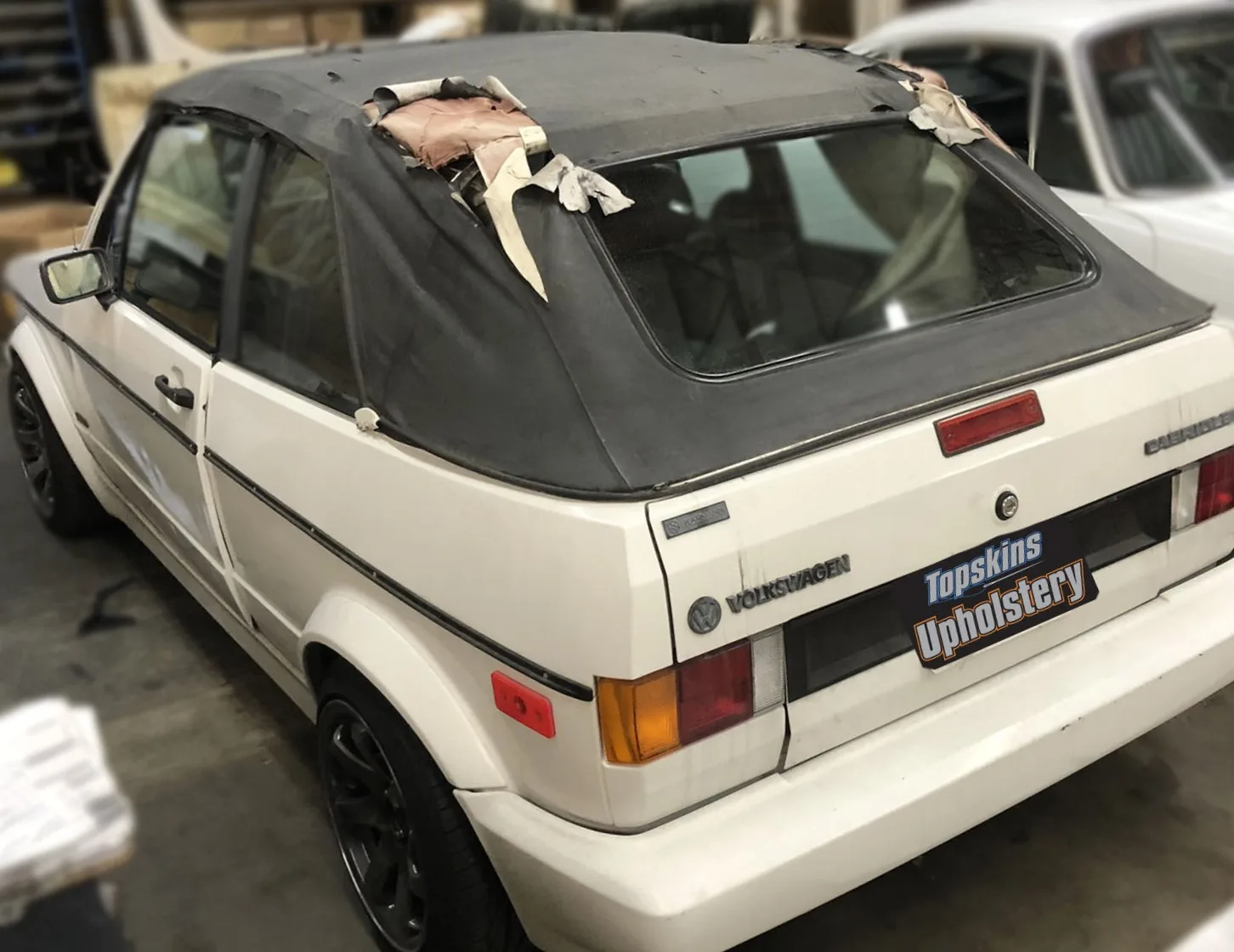 Before picture of a 1988 Volkswagen Cabriolet convertible top replacement, services provided by Topskins Upholstery in Salt Lake City, Utah and surrounding areas.